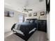 Cozy bedroom features a comfortable bed, ceiling fan, and artwork, creating a relaxing retreat at 13538 Willow Bluestar Loop, Riverview, FL 33579