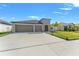 Charming single-story home with a well-manicured lawn and a spacious three-car garage at 13538 Willow Bluestar Loop, Riverview, FL 33579
