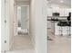Bright hallway leads to kitchen with breakfast bar, enhancing the open and connected feel of the home at 13538 Willow Bluestar Loop, Riverview, FL 33579