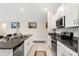 Open-concept kitchen with granite countertops, stainless steel appliances, and a functional island at 13538 Willow Bluestar Loop, Riverview, FL 33579