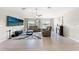 Bright living room with vaulted ceiling, tile flooring, neutral walls, fireplace, and comfortable seating at 13538 Willow Bluestar Loop, Riverview, FL 33579