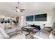 Open-concept living room featuring comfortable seating, tile floors, and kitchen access at 13538 Willow Bluestar Loop, Riverview, FL 33579