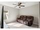 Comfortable living room boasts a plush leather sofa and ceiling fan, perfect for relaxation at 13538 Willow Bluestar Loop, Riverview, FL 33579