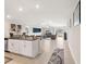 Open floor plan with granite counters, flowing from kitchen to living room with neutral tile flooring at 13538 Willow Bluestar Loop, Riverview, FL 33579