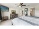 Serene bedroom with a ceiling fan, natural light, and seamless access to the bathroom and walk-in closet at 13538 Willow Bluestar Loop, Riverview, FL 33579