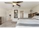 Cozy bedroom featuring neutral tones, carpet flooring, and access to other rooms for a peaceful retreat at 13538 Willow Bluestar Loop, Riverview, FL 33579