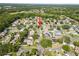Expansive aerial view of a residential neighborhood showcasing well-maintained homes and lush green landscaping, highlighted by a red arrow at 14916 Rocky Ledge Dr, Tampa, FL 33625