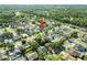 Overhead aerial of neighborhood featuring a collection of well-spaced homes with green lawns and mature trees, indicated by red arrow at 14916 Rocky Ledge Dr, Tampa, FL 33625