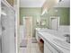 Bright bathroom with double sinks, a walk-in shower, and a soaking tub at 14916 Rocky Ledge Dr, Tampa, FL 33625