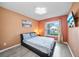 Comfortable bedroom with laminate floors, palm tree wall decor, and a window at 14916 Rocky Ledge Dr, Tampa, FL 33625