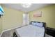 Bedroom with light walls and wood-look floors featuring a wall-mounted TV at 14916 Rocky Ledge Dr, Tampa, FL 33625