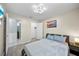Bedroom with light walls, wood-look floors and a closet steps away from an attached bathroom at 14916 Rocky Ledge Dr, Tampa, FL 33625