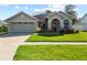 Charming single-story home featuring a well-manicured lawn, two car garage, and neutral exterior paint at 14916 Rocky Ledge Dr, Tampa, FL 33625