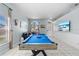 Game room with pool table, seating, large windows, and a view of the front yard at 14916 Rocky Ledge Dr, Tampa, FL 33625