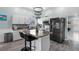 Well-lit kitchen with white cabinets, stainless steel appliances, and center island with seating at 14916 Rocky Ledge Dr, Tampa, FL 33625