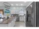 Well-lit kitchen with white cabinets, stainless steel appliances, and center island with seating at 14916 Rocky Ledge Dr, Tampa, FL 33625