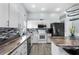Well-lit kitchen with white cabinets, stainless steel appliances, and center island with seating at 14916 Rocky Ledge Dr, Tampa, FL 33625