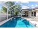 Inviting screened-in pool and patio featuring dining and lounge area at 14916 Rocky Ledge Dr, Tampa, FL 33625