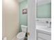 Cozy powder room featuring tiled floor, toilet, and vanity with sink at 14916 Rocky Ledge Dr, Tampa, FL 33625