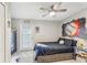 Nicely decorated bedroom featuring baseball-themed décor, a ceiling fan, and access to the backyard at 16242 Rambling Rd, Odessa, FL 33556