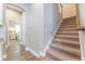 Carpeted staircase with wood handrail and trim; entry view to bedroom through arched doorway at 1767 Tonka Ter, Wesley Chapel, FL 33543