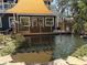 Charming backyard pond view from the deck, surrounded by mature landscaping and tranquil water features at 2005 Jackson N St, St Petersburg, FL 33704
