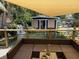 Beautiful backyard boasts a cozy lounge area, pond, waterfall and an outdoor kitchen with counter seating at 2005 Jackson N St, St Petersburg, FL 33704
