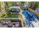 Aerial view of backyard featuring a pool, pond, lush landscaping and outdoor amenities at 2005 Jackson N St, St Petersburg, FL 33704