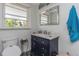 Bathroom showcasing a vanity with dark wood, granite countertop, and natural light at 2005 Jackson N St, St Petersburg, FL 33704