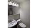 A partial bathroom that features a sink and toilet and a mirror view into the glass shower at 2005 Jackson N St, St Petersburg, FL 33704