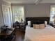 Bedroom showcasing natural light, a cozy upholstered headboard, and hardwood floors at 2005 Jackson N St, St Petersburg, FL 33704