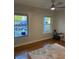 Bright room featuring hardwood floors, windows overlooking a pool, and a ceiling fan at 2005 Jackson N St, St Petersburg, FL 33704
