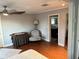 Cozy bedroom featuring wood floors, stylish furniture, and ensuite bathroom entrance at 2005 Jackson N St, St Petersburg, FL 33704