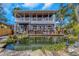 View of the charming two-story home with pond in foreground from the backyard at 2005 Jackson N St, St Petersburg, FL 33704
