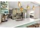 Bright kitchen with white countertops, light green cabinetry, pendant lights, and stainless steel appliances at 2005 Jackson N St, St Petersburg, FL 33704
