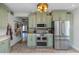 Modern kitchen with stainless steel appliances and light green cabinets at 2005 Jackson N St, St Petersburg, FL 33704