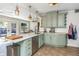 Bright kitchen featuring light green cabinetry, white countertops, stainless steel appliances, and tile floors at 2005 Jackson N St, St Petersburg, FL 33704