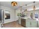 Light green kitchen with stainless steel appliances, white countertops, and an adjacent dining area at 2005 Jackson N St, St Petersburg, FL 33704