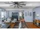 View of a cozy living room with hardwood floors, a ceiling fan, open to the kitchen, and well appointed with furniture at 2005 Jackson N St, St Petersburg, FL 33704