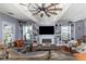 Bright living room featuring hardwood floors, a ceiling fan, fireplace, and built-in shelving showcasing decorative items at 2005 Jackson N St, St Petersburg, FL 33704