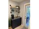 Mudroom featuring a sink, cabinets, shelves, and an exterior door leading to the deck at 2005 Jackson N St, St Petersburg, FL 33704