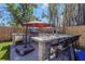 Outdoor kitchen featuring a built-in grill, pizza oven, stainless steel refrigerator, and bar seating at 2005 Jackson N St, St Petersburg, FL 33704
