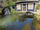 Backyard storage shed near tranquil pond featuring a waterfall, lush greenery, and calming water features at 2005 Jackson N St, St Petersburg, FL 33704