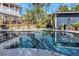 Gorgeous backyard pool surrounded by lush landscaping and a pool house at 2005 Jackson N St, St Petersburg, FL 33704