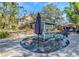 Inviting backyard pool surrounded by lush greenery, with an umbrella for shaded relaxation at 2005 Jackson N St, St Petersburg, FL 33704