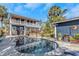 Inviting pool with stone surround and palm trees, reflecting the home's exterior under a blue sky at 2005 Jackson N St, St Petersburg, FL 33704