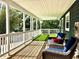 Cozy porch with artificial turf, wood flooring and outdoor seating provides a relaxing spot at 2005 Jackson N St, St Petersburg, FL 33704