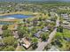 High angle view showcases a residential area featuring a pond, mature trees, and a well-connected road network at 2009 Halidom Way, Sun City Center, FL 33573