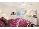 Cozy bedroom with white dressers, plush bedding, and a bright window at 2009 Halidom Way, Sun City Center, FL 33573