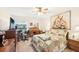 Comfortable bedroom with a ceiling fan, large floral painting, and a cozy, colorful quilt at 2009 Halidom Way, Sun City Center, FL 33573